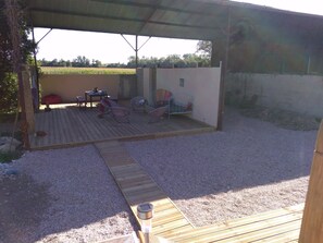 shaded sitting and dining area near the pool and away from the house