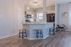 Breakfast Bar Adds to Your Workspace - The breakfast bar doubles as extra work space in the kitchen. With this much space you can easily feed a crowd here!