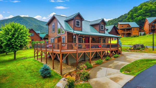 The wraparound porch and semi-circular driveway are bonus amenities.