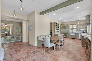 Large dinning table with bench seating.