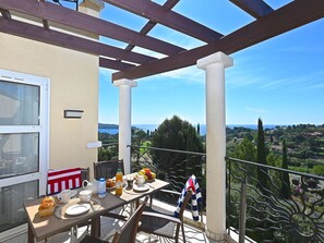 Sky, Property, Table, Window, Tableware, Flowerpot, Building, Shade, Chair, Porch