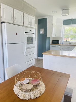 Kitchen and eating space. Oven, stovetop, and dishwasher. 