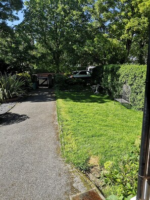 Sun drenched garden with seating and playing area for the family  secure gate