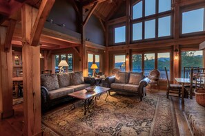 Large open concept living room situated to capture the plentiful amounts of glowing natural light