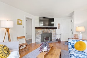 65” Smart TV is perched over the classic indoor fireplace