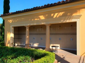 Community outside showers next to pool