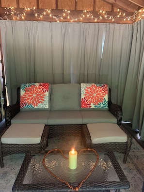 Cozy screened-in porch seating for chatting into the night
