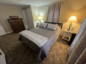 Master bedroom is large for a 100 year old farmhouse! TV, dresser, mirror & more