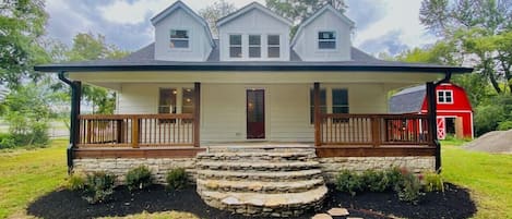 Front of the home with gorgeous porch and rocking chairs