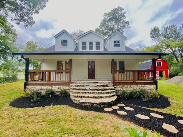 Front of the home with gorgeous porch and rocking chairs