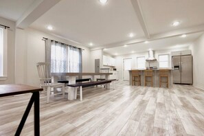 View from the family room of the large table and kitchen area