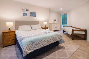 Master bedroom with queen bed, walk-in wardrobe and en suite. Please note the small bed has a foam mattress and is only suitable for toddlers. It will only be made up on request.