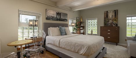 A cozy bedroom with polished hardwood floors and a neatly made bed, creating a warm and inviting atmosphere.