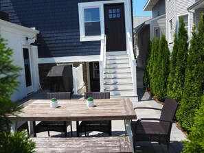 Back patio with dining area and Weber grill