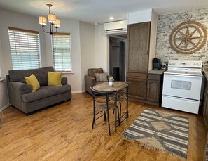 Reclaimed wood floors and comfy oversized loveseat and sitting chair