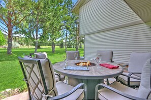 Outdoor dining area with gas firepit and gorgeous golf course views