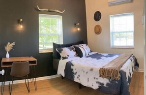 Master bedroom with queen size bed, bull theme and a 55" smart TV