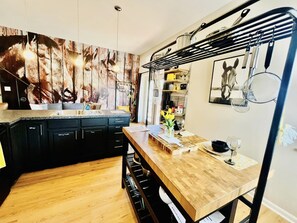 Light filled kitchen with two (2) additional seating and professional grade stainless steel cookware for homecooked meals
