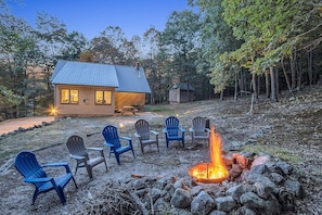 Backyard fire pit for spring, summer, and fall use, guests provide own wood.