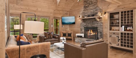 Welcome to the heart of coziness and convenience. This modern, tastefully decorated living room with a fireplace, access to dining and a walk-out porch, laundry, a queen-size bedroom, and a fully equipped kitchen is your perfect retreat.