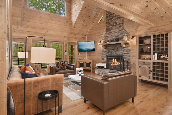 Welcome to the heart of coziness and convenience. This modern, tastefully decorated living room with a fireplace, access to dining and a walk-out porch, laundry, a queen-size bedroom, and a fully equipped kitchen is your perfect retreat.