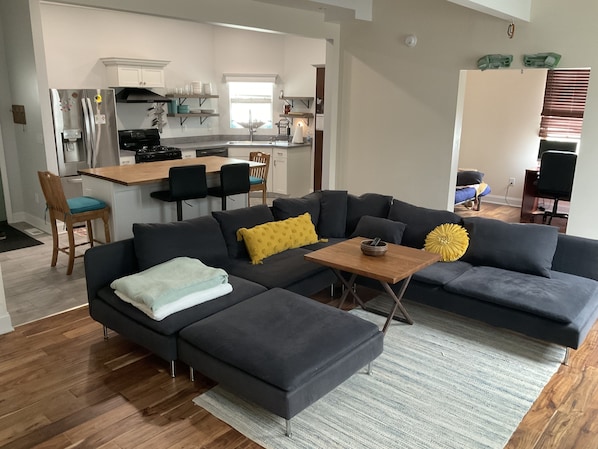 Open living room/kitchen space, looking into the office.