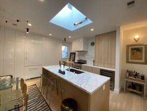 Paneled pantry and Refrigerator. Skylight.