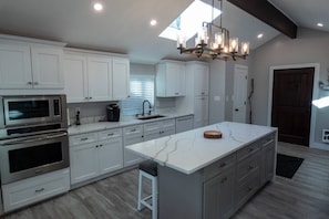 Chef's kitchen with wall oven and microwave