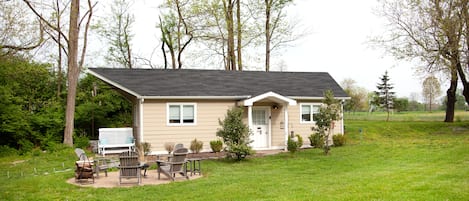 This charming and cozy cottage features a king bed and fire pit. 