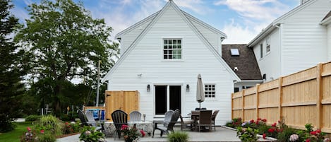 Beautiful back yard and patio with grill, outdoor shower, gas fire pit and table