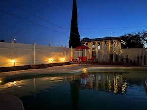 When the sun sets, the backyard is the place to be. Enjoy a night swim, a beer on the patio, or head out to the magically lit pergola where you'll find more seating and a bar!