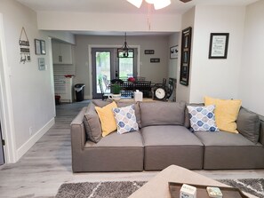 Open concept living room with a soft and comfortable sofa.