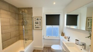 Spacious bathroom includes shower and bath