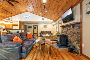 Inviting and warm Great Room with custom wood work and stone wall.