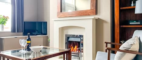 Living room, featuring a fireplace and smart tv.