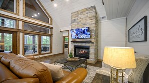 Living Area with Couch, Chair, TV and Fireplace.