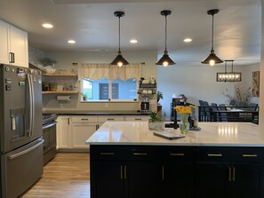 Fully stocked kitchen, gas stove, coffee and tea station.