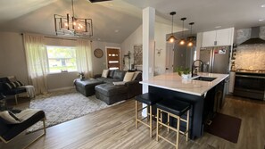 Views of the large island, kitchen and living area. 