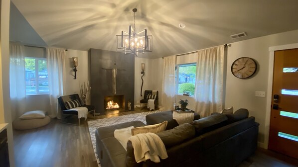 Open concept living area, modern lighting and design adjoining to chef's kitchen
