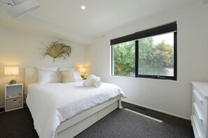 Bedroom 3 with queen bed, ceiling fan and draws