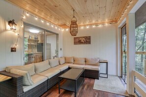 On the back porch is a lovely screened-in lounge area.