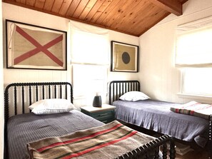 Second bedroom with twin beds, quilts and wool blankets