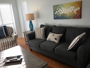 A new couch, love seat and comfortable chair with lots of natural light 