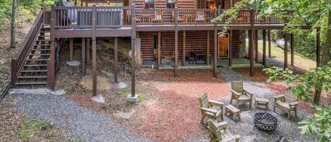 Rear view of fire pit, hot tub, and outdoor seating