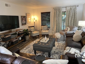 Spacious living area with ample seating and widescreen tv