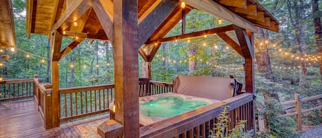 Relax and unwind in the hot tub or rocking chair, beautifully lit outdoors