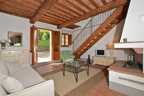 The living-room and the wood stairs for the upper level