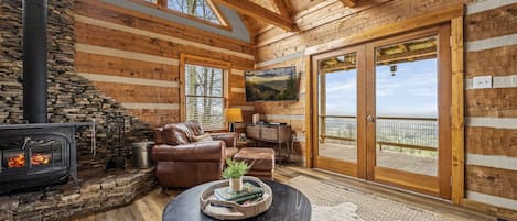 Open-concept living area with smart TV & entrance to deck.