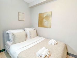 Large double bed in a well-lit room