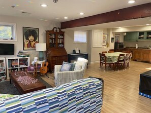 Living room and dining room with electric keyboard.